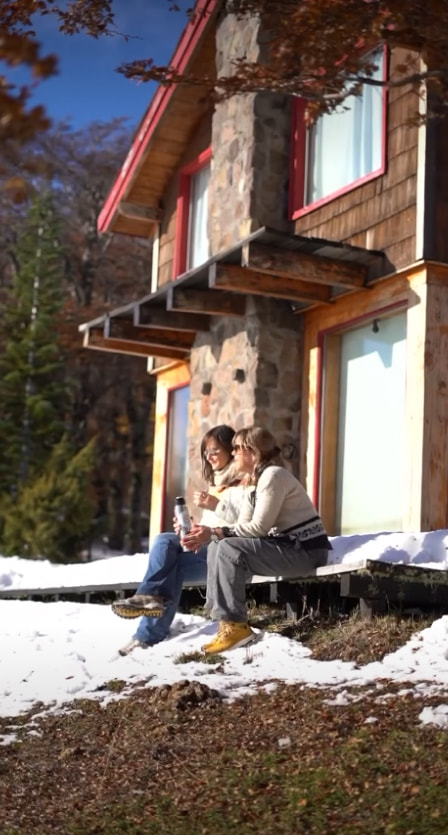 A couple spending time outside their mountain home
